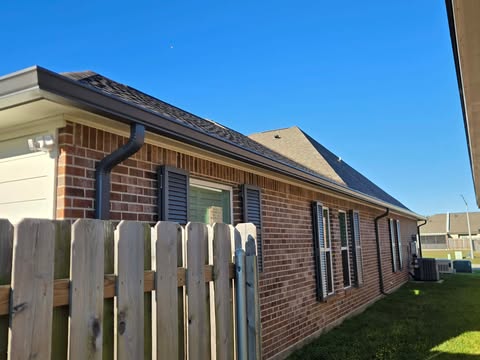 Black seamless gutters on brick home
